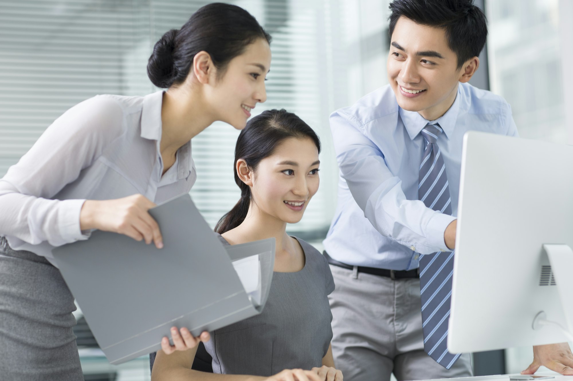 Young business people using computer in office