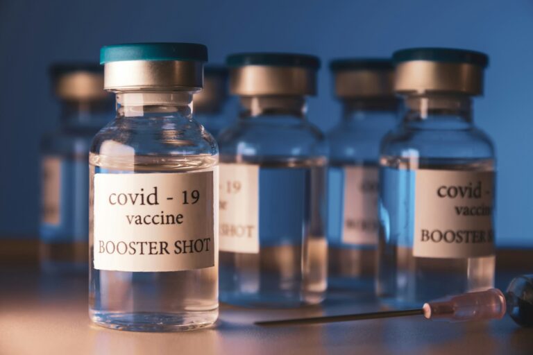 COVID-19 booster vaccine vial. Medicine and health care concept