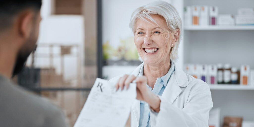 Happy senior woman, pharmacist and patient in consultation for medication or prescription at pharma