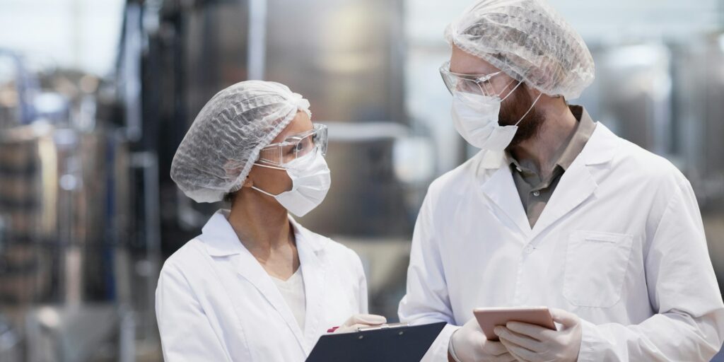 Two Workers at Pharmaceutical Factory