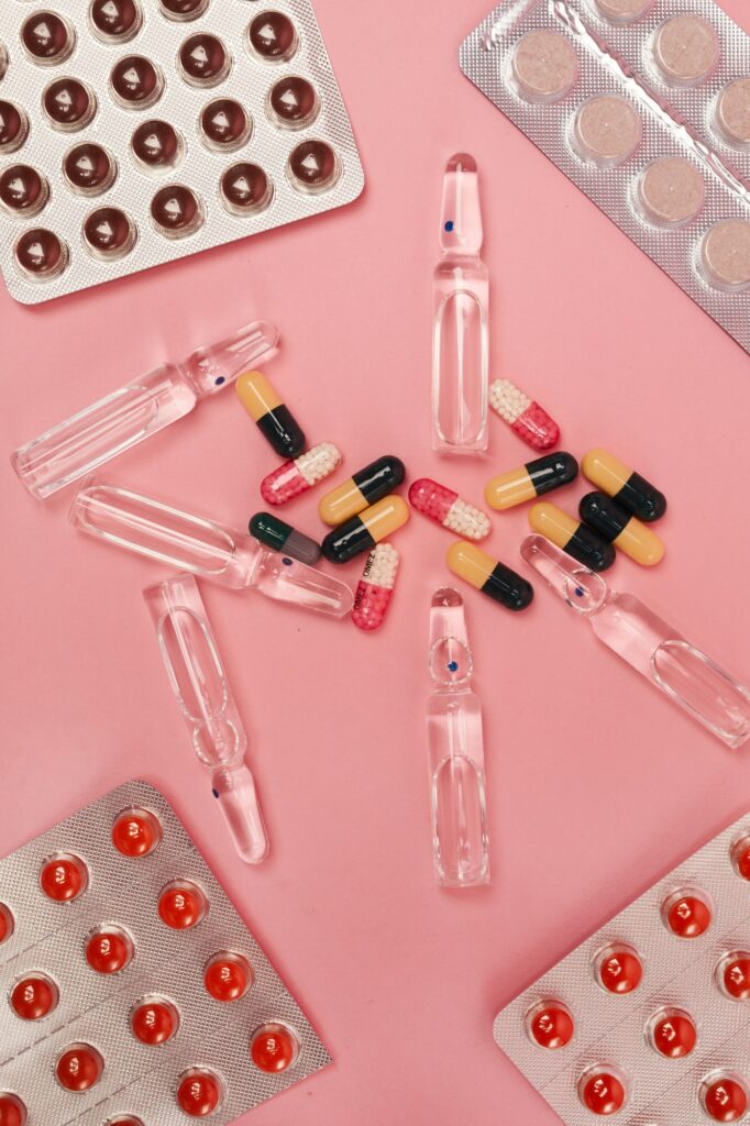 Various Medication on Pink Background