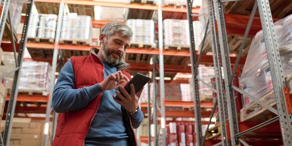 Warehouse worker checking stock with tablet pc