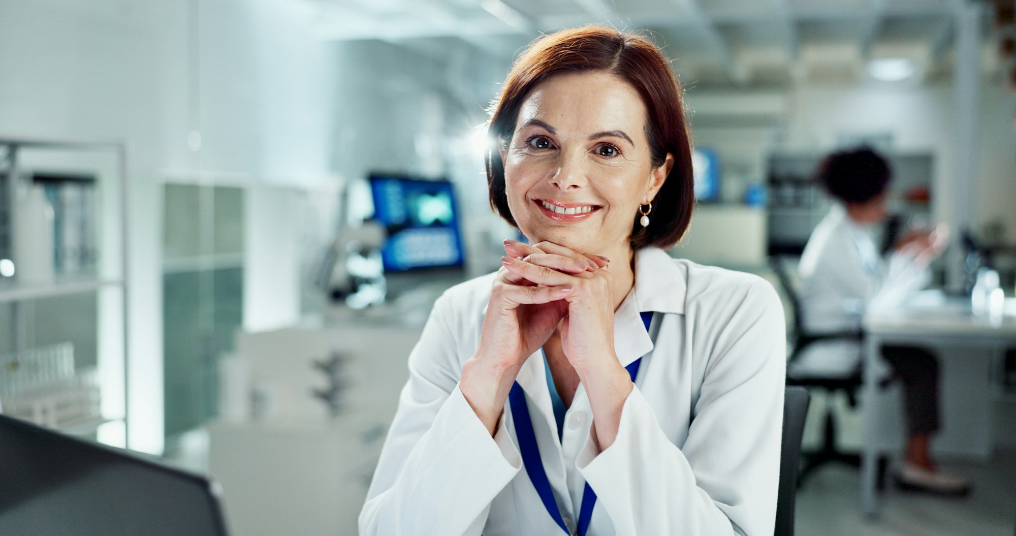 Woman, happy and portrait in laboratory with research for medicine, vaccine and drugs at pharma com