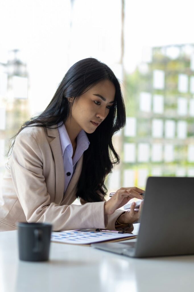 Woman working on paperwork on the desk.