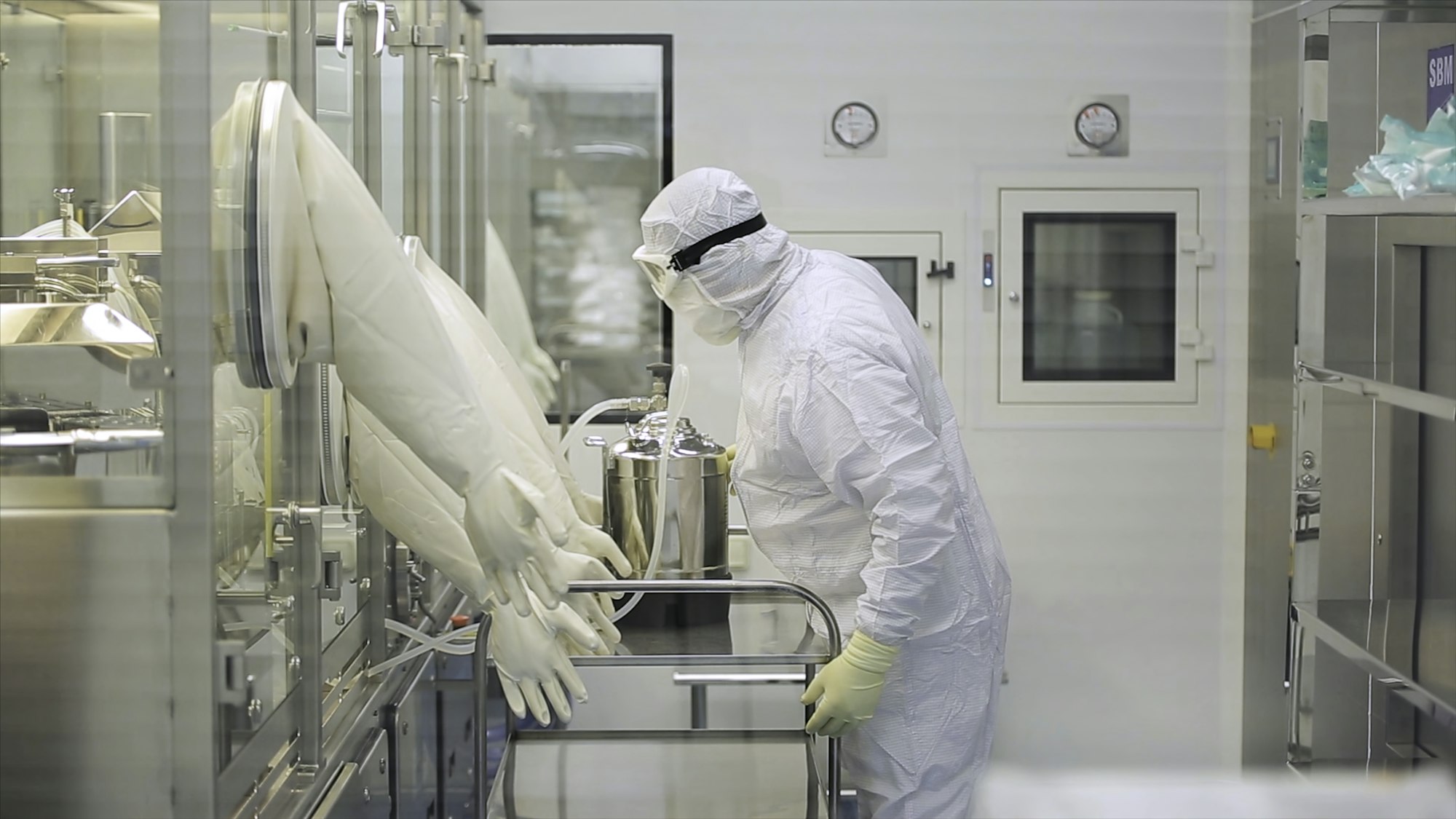 Worker At Pharmaceutical Factory. Lab technician working inside a pharmaceutical factory