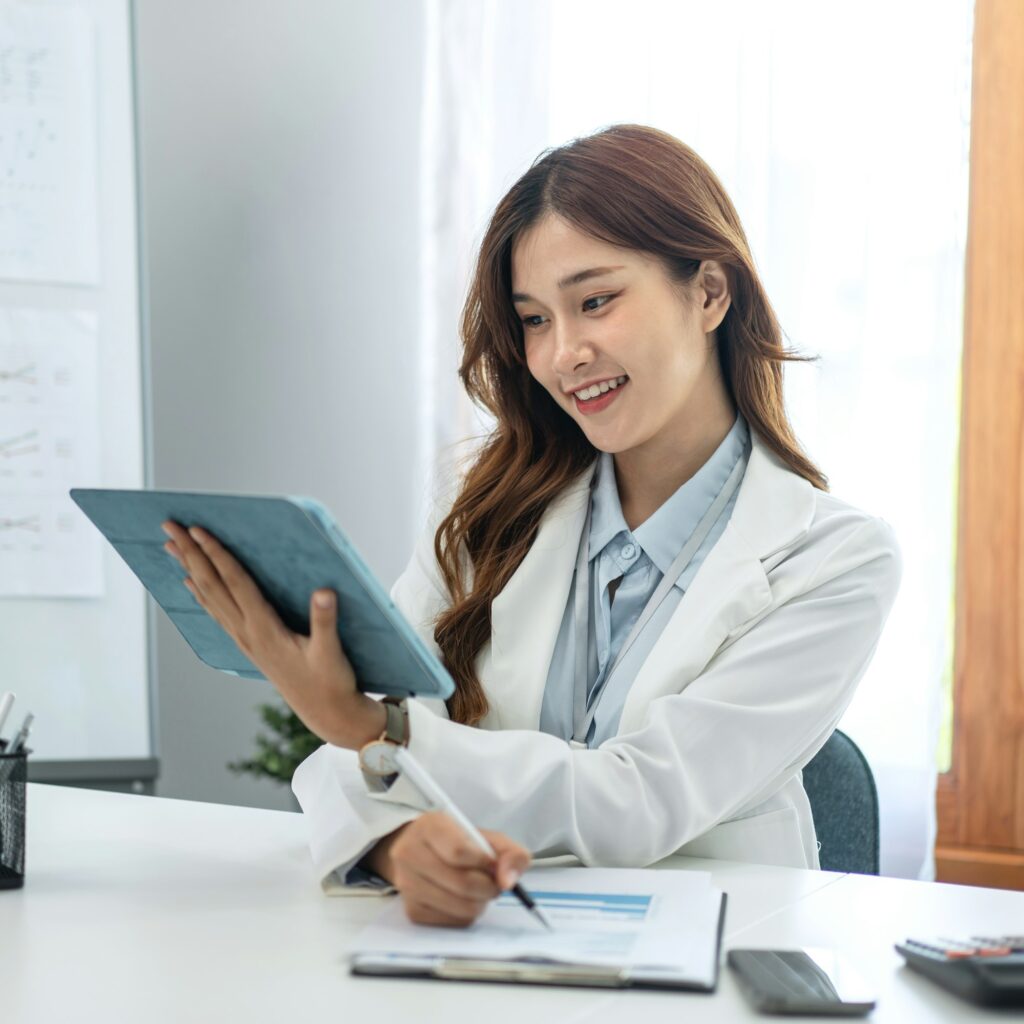 Businesswoman in suit reading business data on tablet and taking