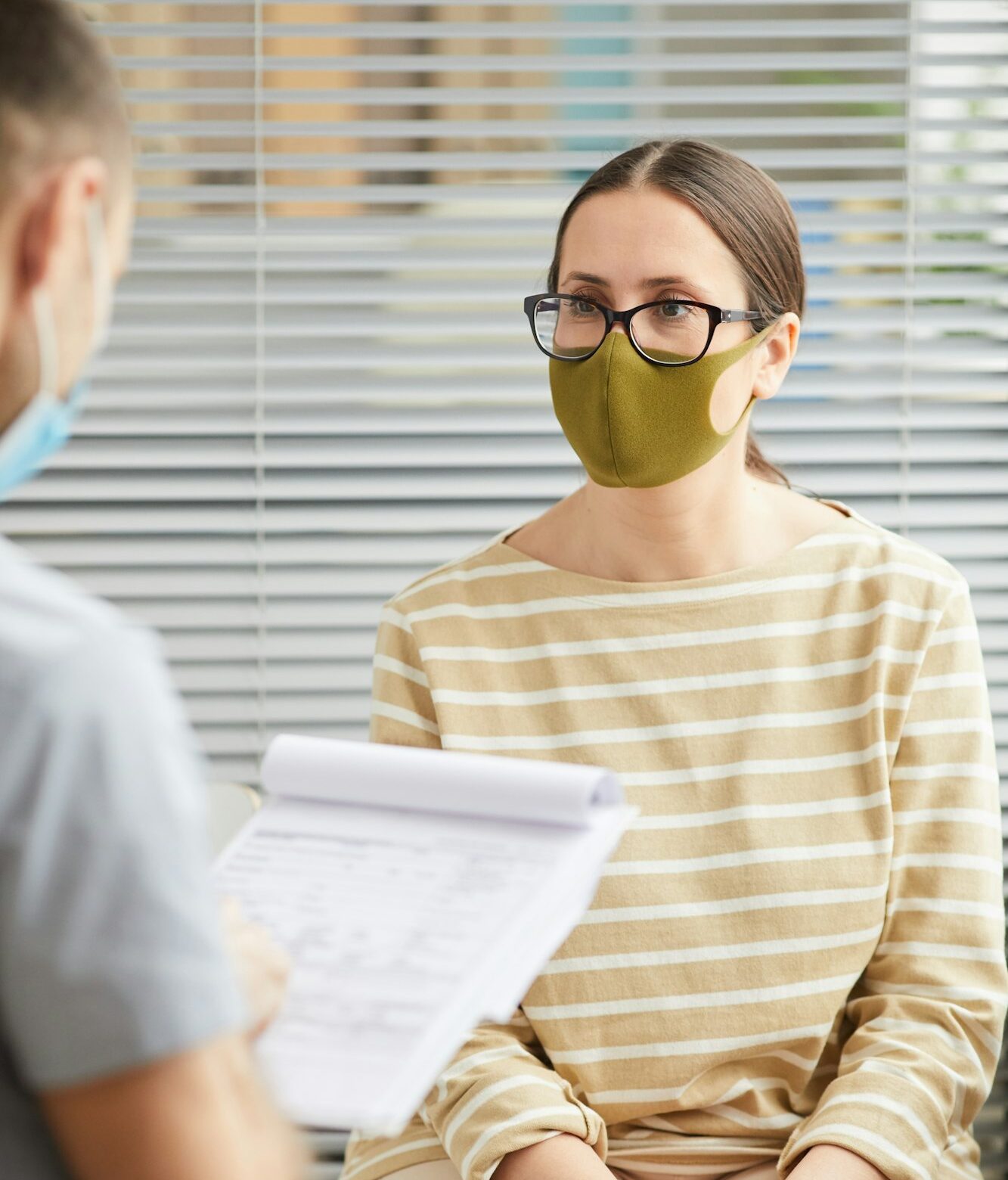 Doctor Talking to Woman in Line