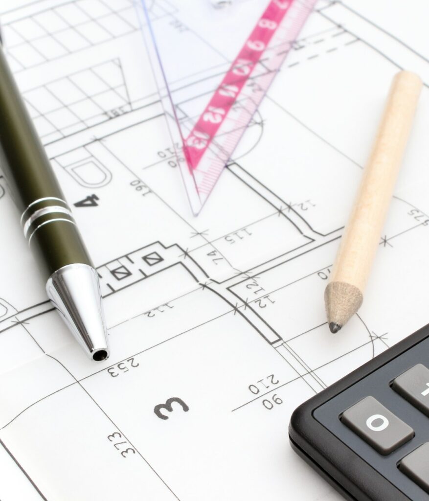 Drawing accesories and calculator on housing plan, building home cost concept