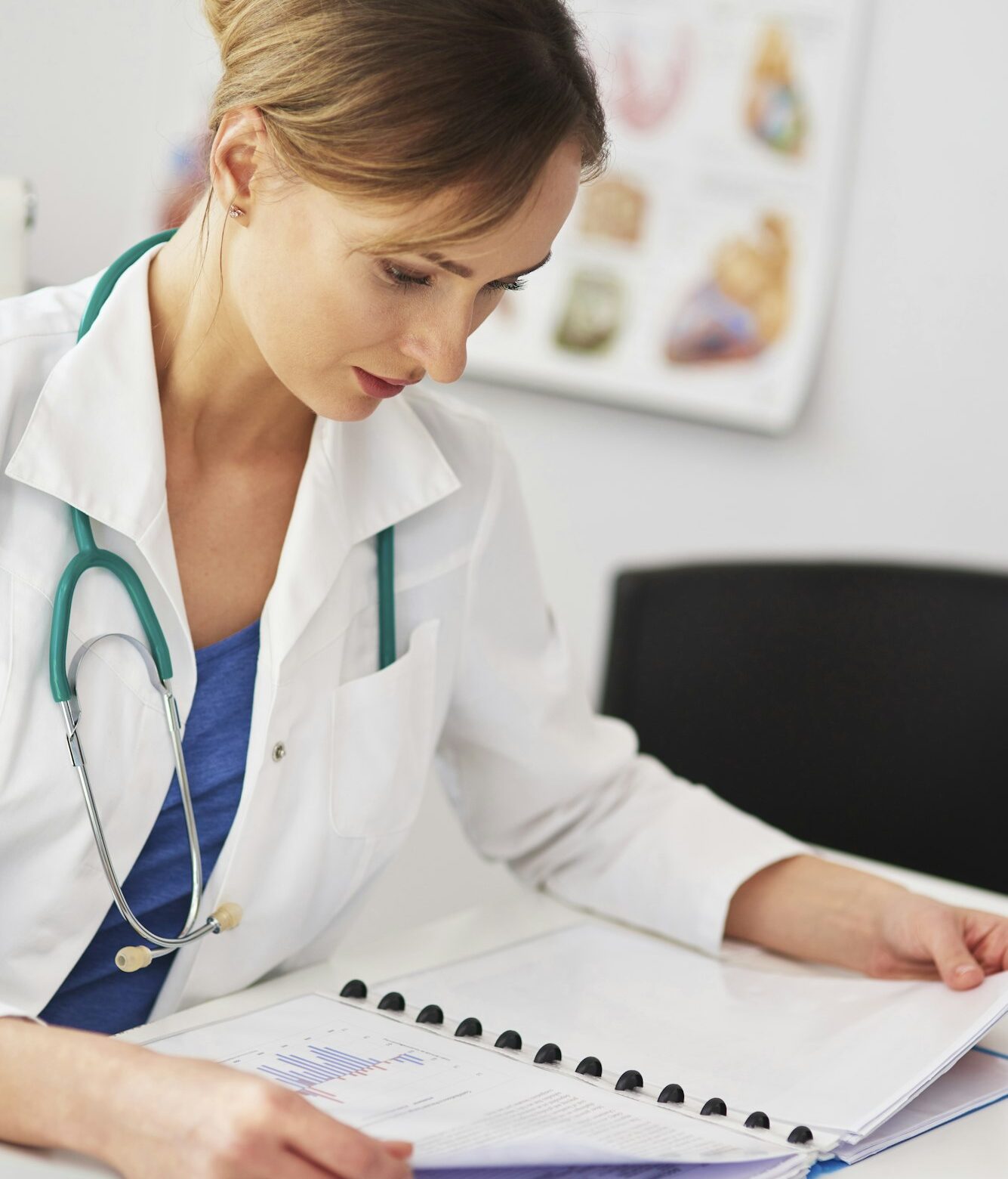 Female doctor examining the medical record Female doctor examining the medical record