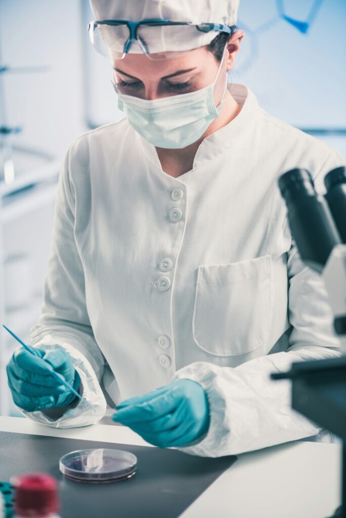 Microbiologist inspecting petri dish, observing bacteria growth