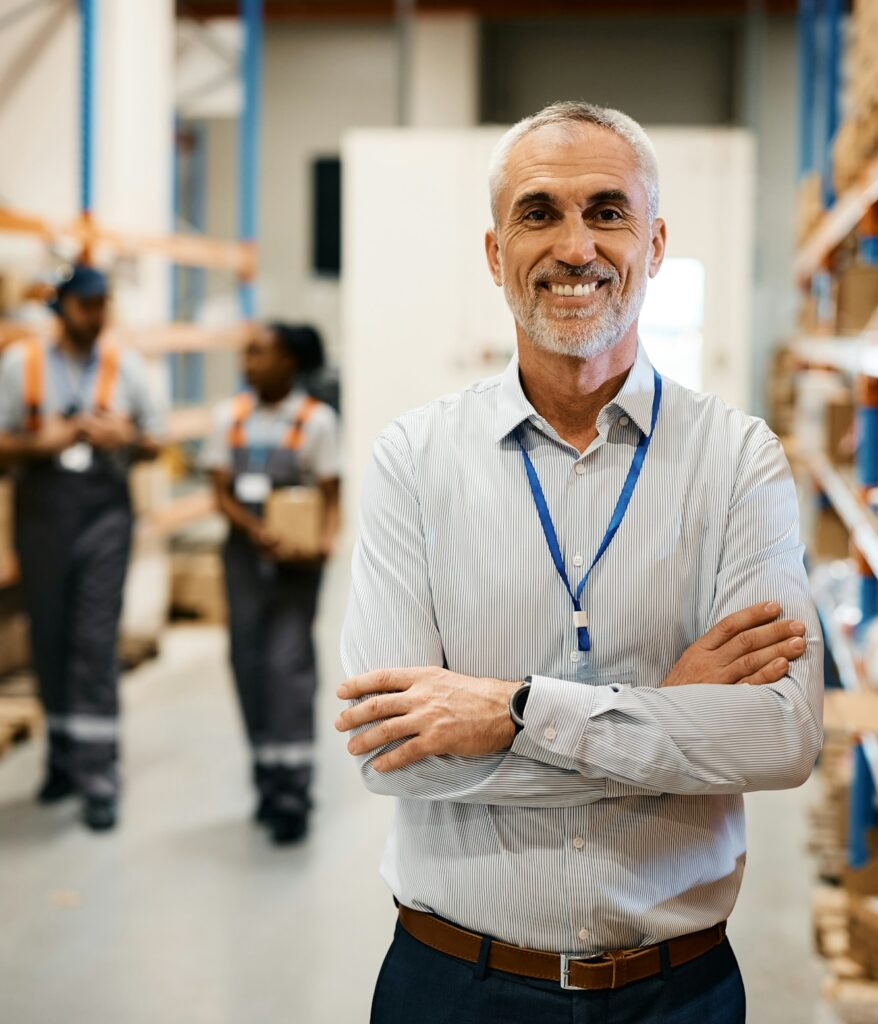 Portrait of confident mature manager of distribution warehouse looking at camera.