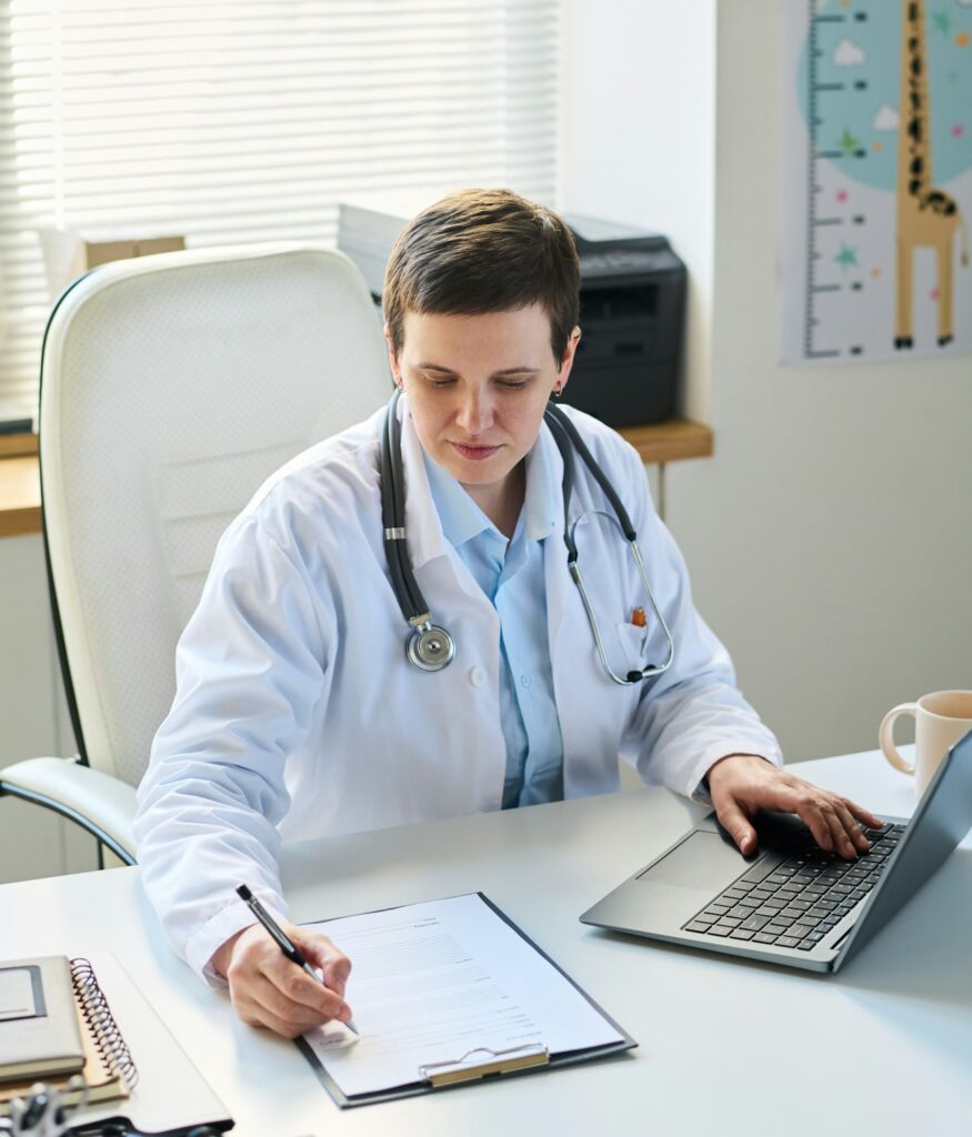 Portrait of Female Doctor Reviewing Patient Records