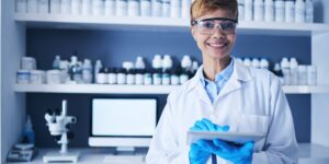 Science, tablet and black woman in laboratory for experiment, pharma innovation and planning. Portr