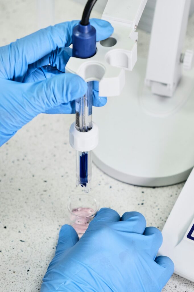 woman-in-a-rubber-gloves-holding-a-glass-electrode-for-measuring-of-ph