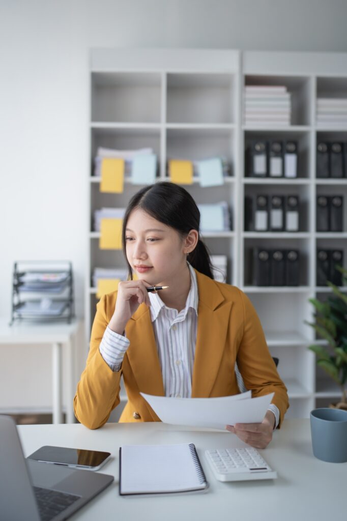 woman-plans-a-finance-and-budget-audit-by-reviewing-organizing-office-financial-documents-682x1024