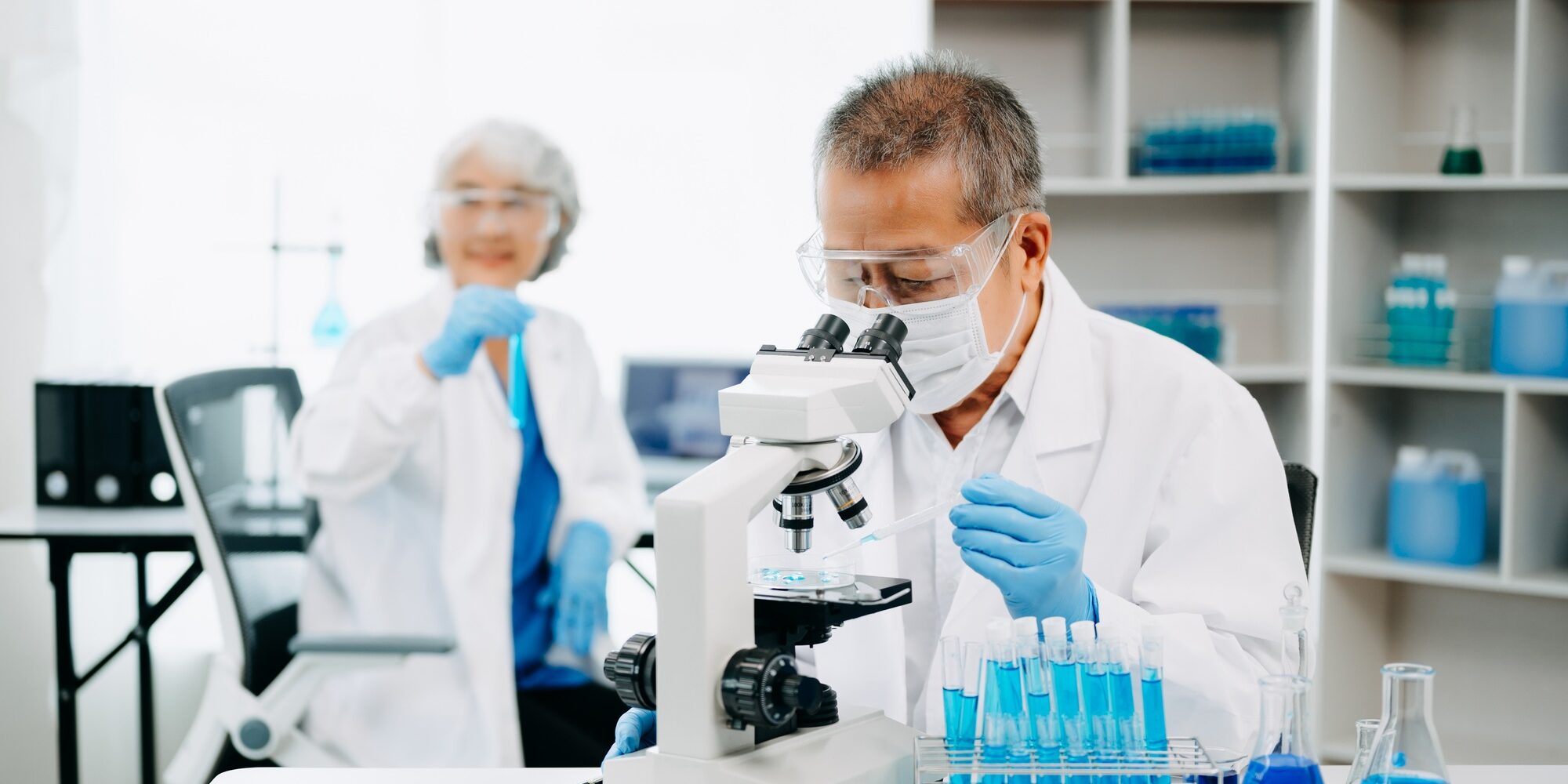 Scientist team meeting and writing analysis results in the laboratory