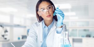 Female lab technician analyzing liquid sample