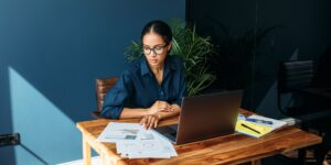 Young woman working with documents from home