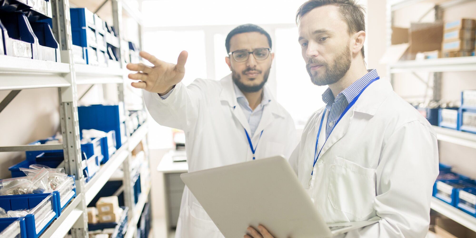Busy factory lab technicians keeping records of devices