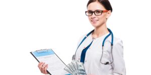 Young beautiful female doctor holding clipboard and money in her hands on white background