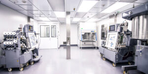 Wide view of a regulated pharmaceutical manufacturing facility during a quality inspection, illustrating pharmaceutical GxP compliance, GxP inspection readiness, quality risk management, data integrity expectations, and pharmaceutical governance systems.