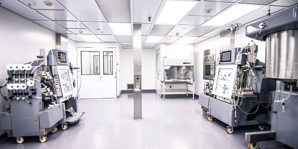 Wide view of a regulated pharmaceutical manufacturing facility during a quality inspection, illustrating pharmaceutical GxP compliance, GxP inspection readiness, quality risk management, data integrity expectations, and pharmaceutical governance systems.